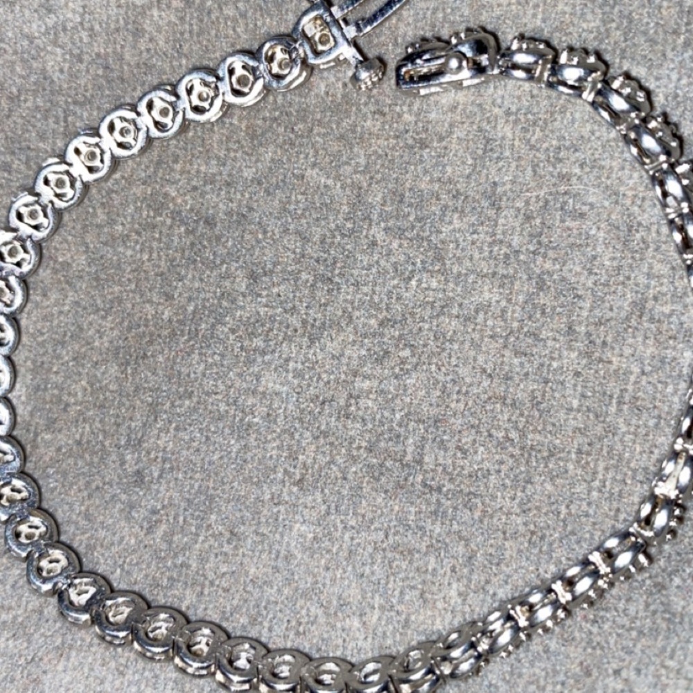 Sterling silver with diamonds 44 to be exact!